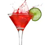 Red cocktail with splash and lime isolated on white